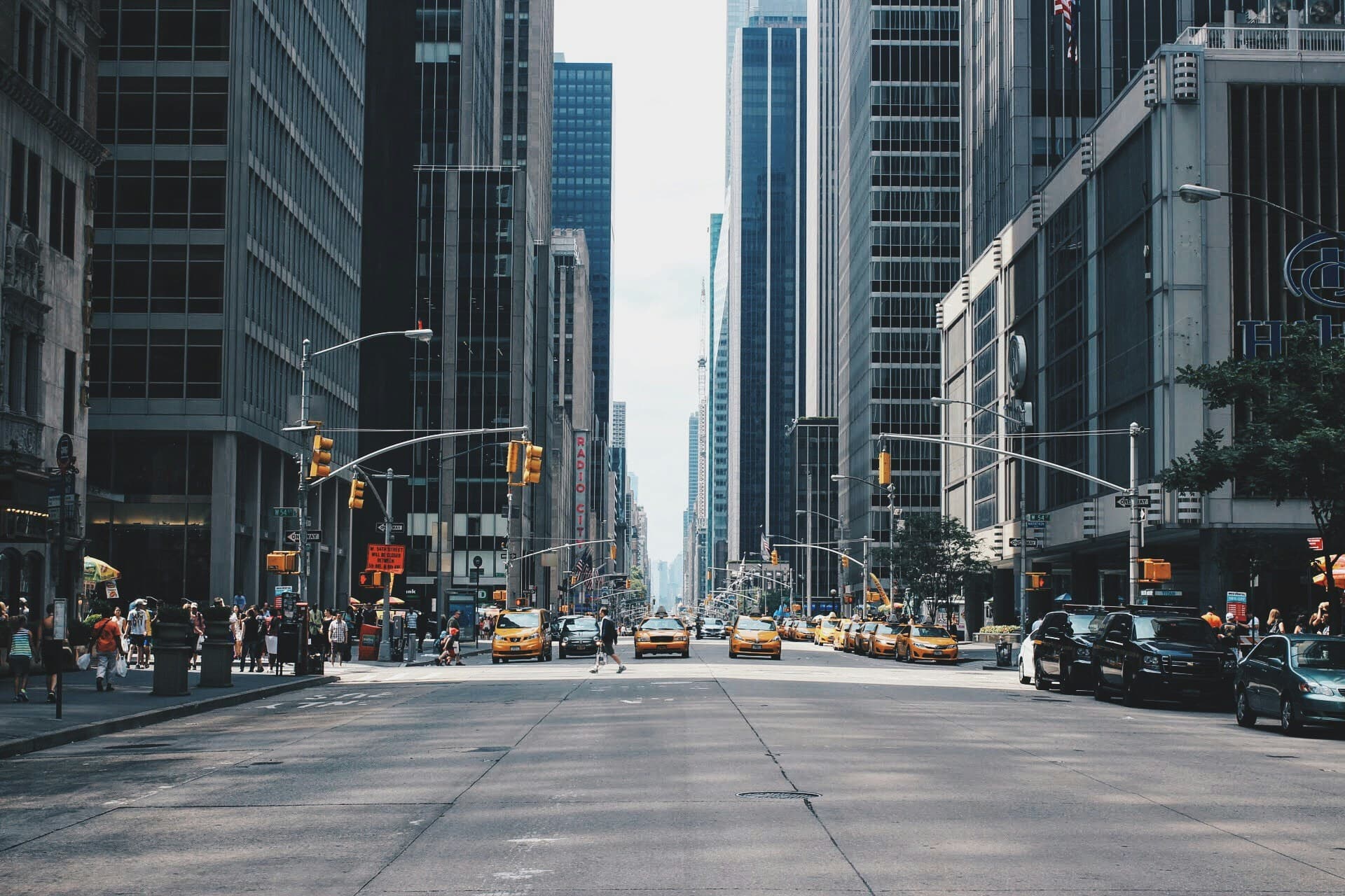 Urban street lined with mixed-use buildings in daylight