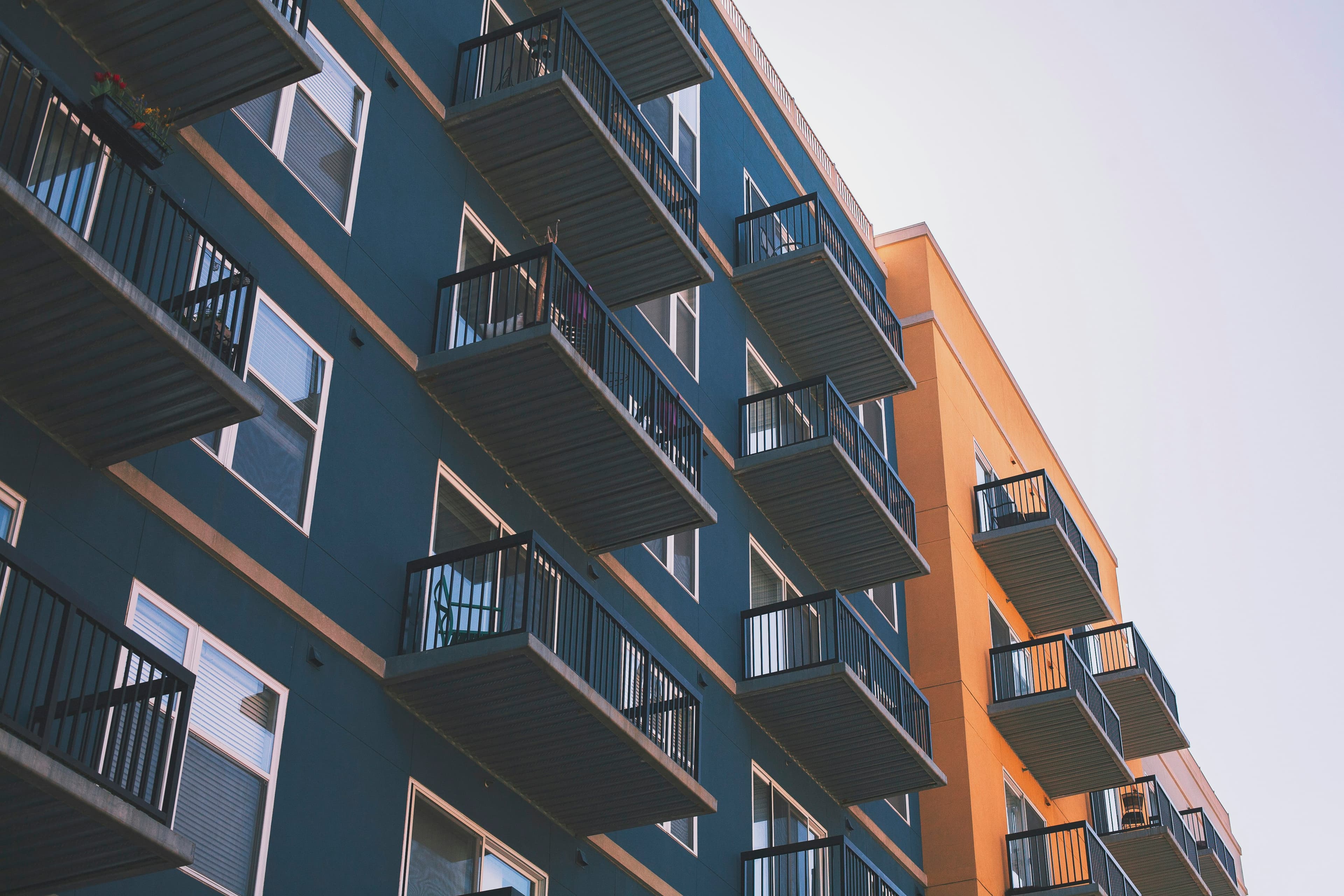 Contemporary apartment building with balconies and warm cladding